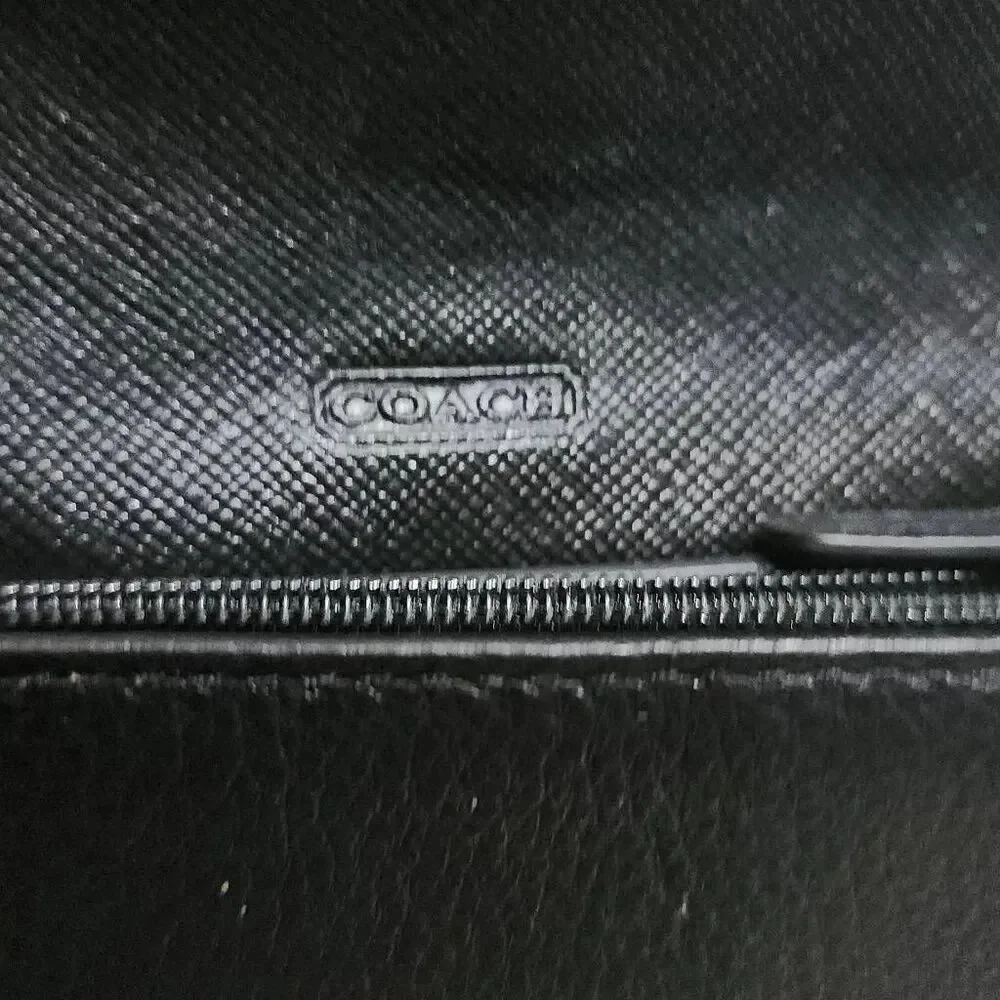 Coach Avery leather phone crossbody w/ a flap closure.